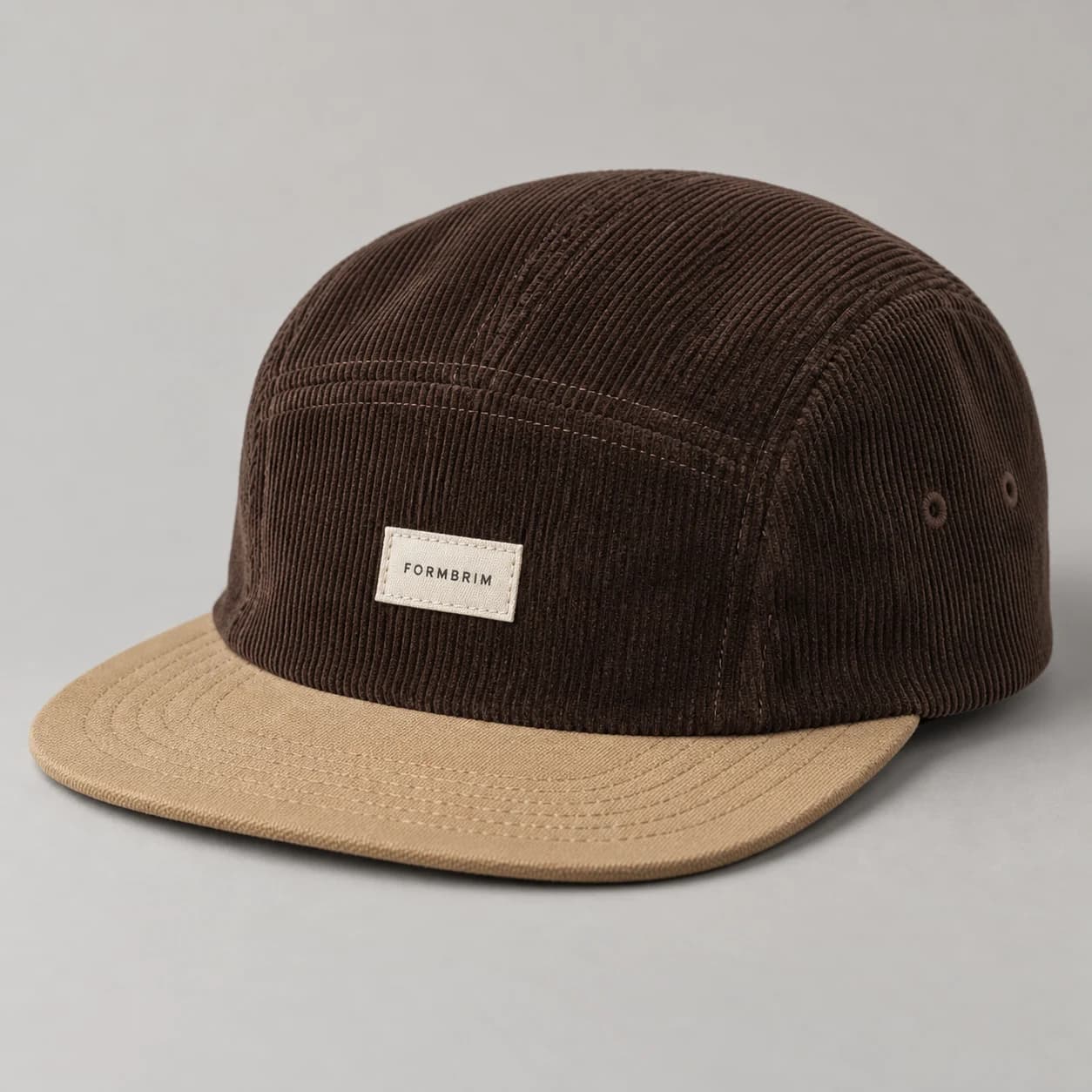 AI-generated corduroy camp cap design reference illustrating soft camp crown / flat brim